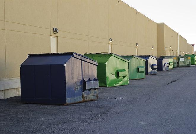 a collection of bright and vibrant dumpsters in a construction zone in Amityville, NY